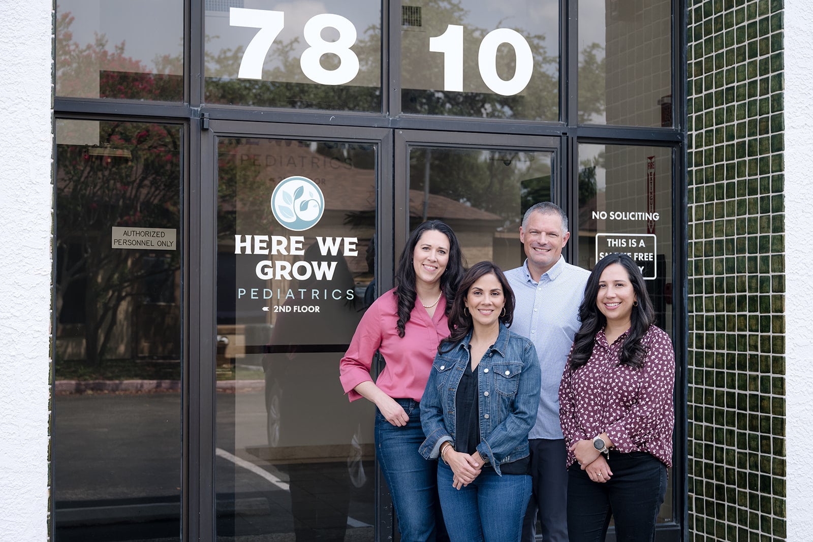 The Here We Grow Pediatrics team outside the practice entrance at 7810 Louis Pasteur Drive in San Antonio