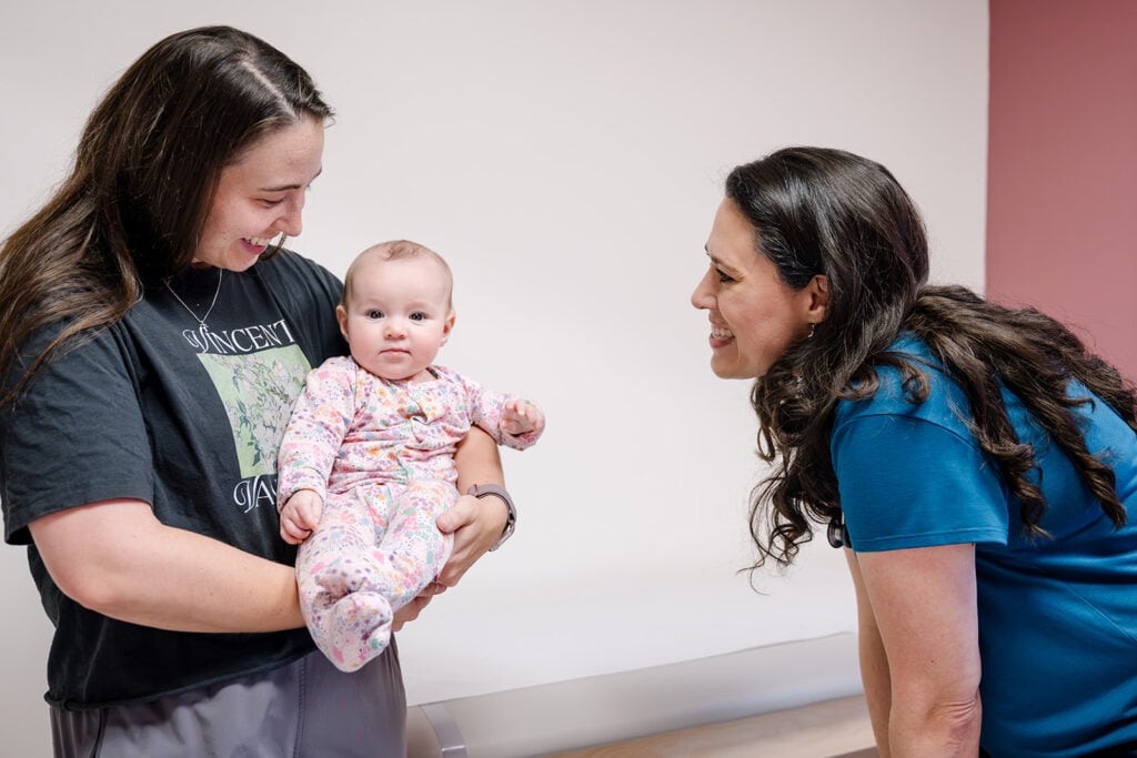 A parent and a Here We Grow provider talking during a visit