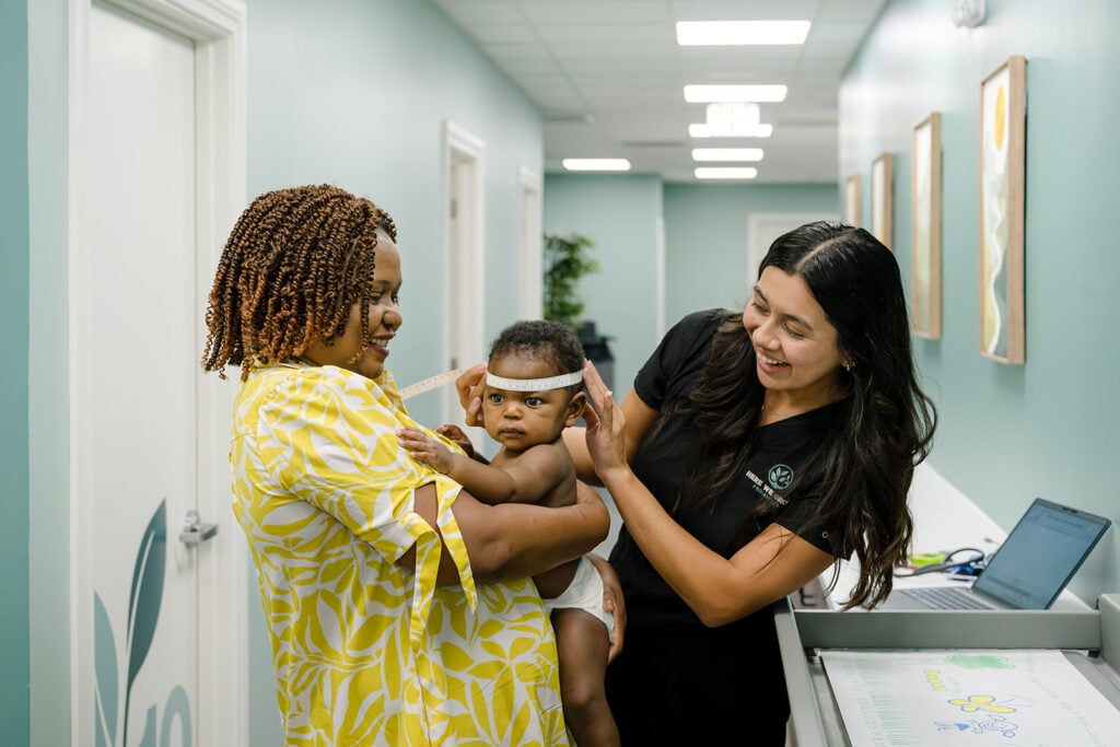 A parent and newborn with a Here We Grow provider